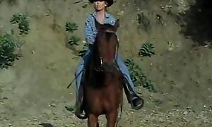 Young incomparable blonde was riding the horse when she has  met pulling cowboy